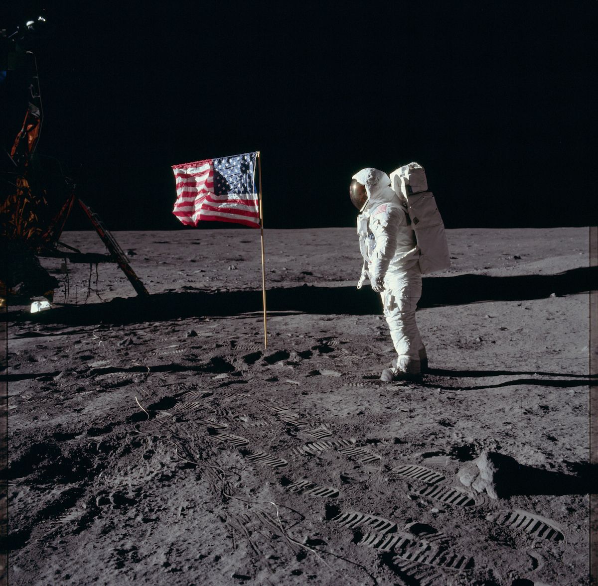 Astronaut planting the American flag on the moon.