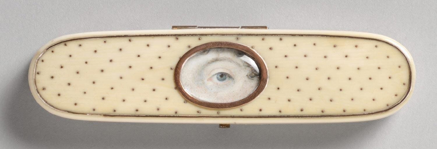 Top view of an oval snuff box with a miniature portrait of an eye centered on the lid.