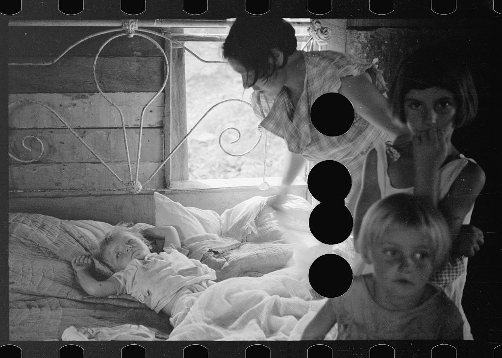 A black and white photograph of a sick child in bed with a woman and three children looking on.