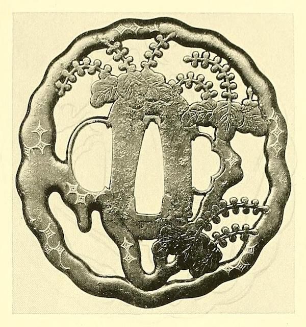 Vintage illustration of a Japanese tsuba with a flower and branch design.