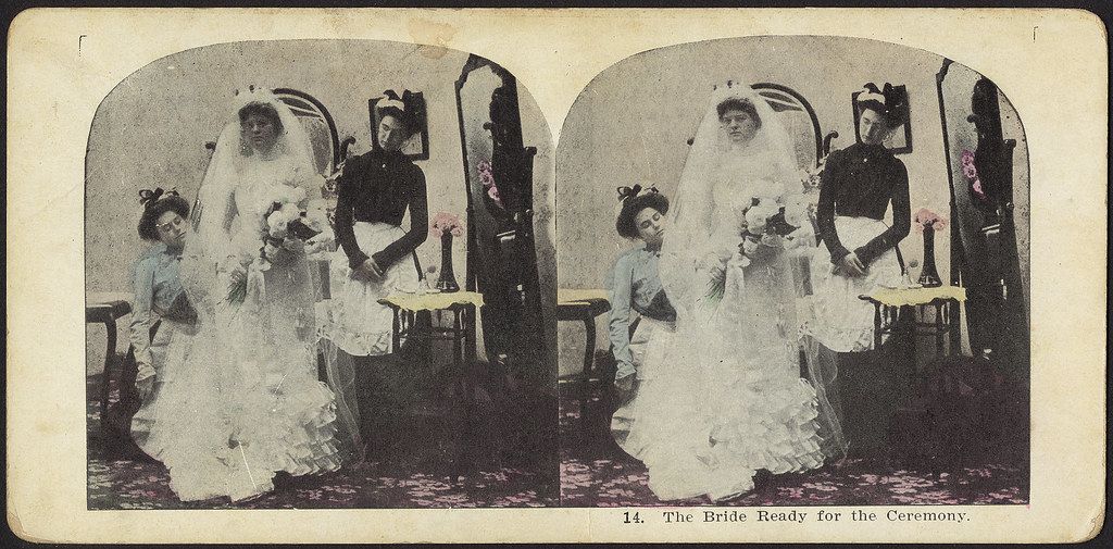 Stereoscopic photograph of a bride and bridesmaids preparing for a wedding ceremony.