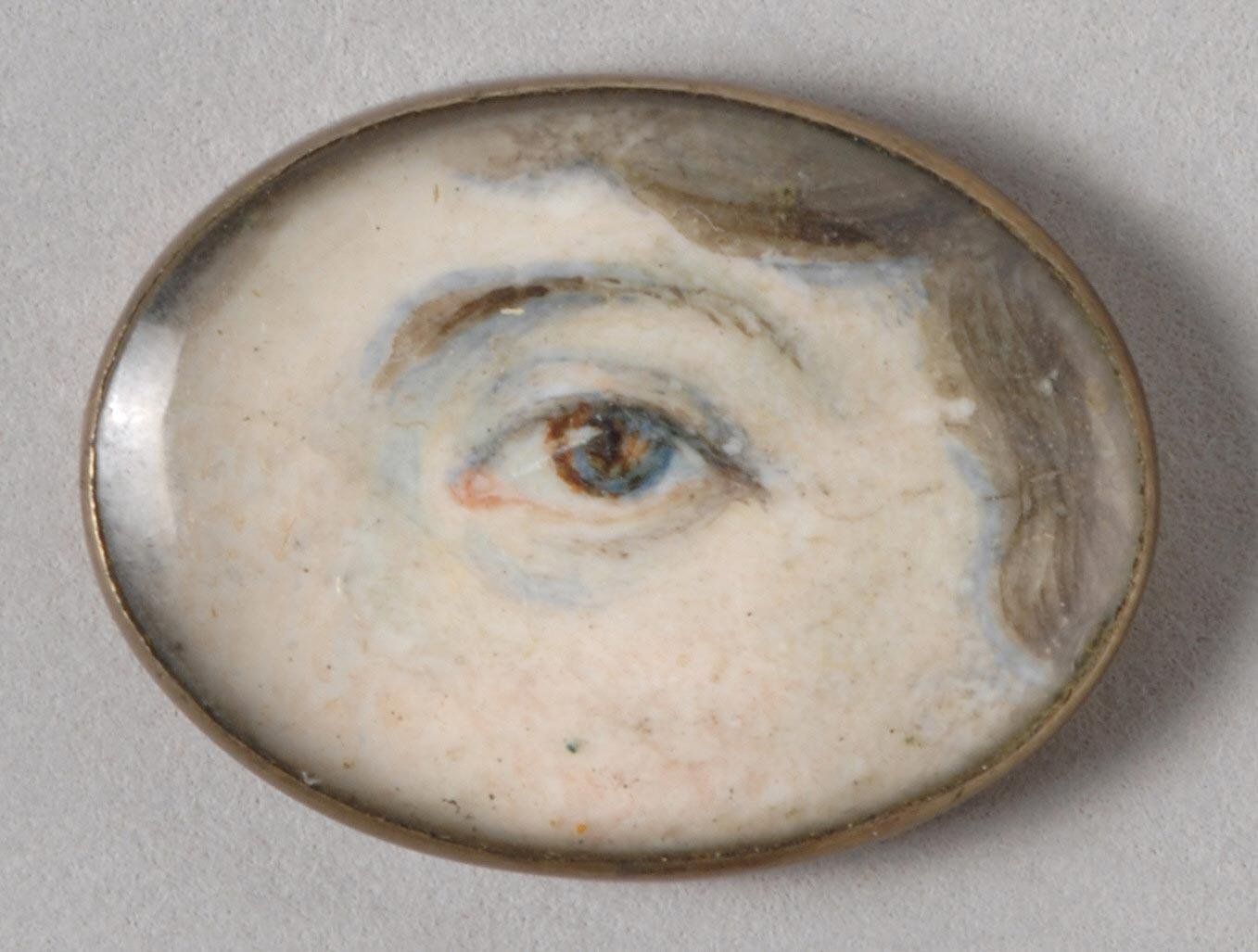 Close-up portrait of an eye within an oval frame.