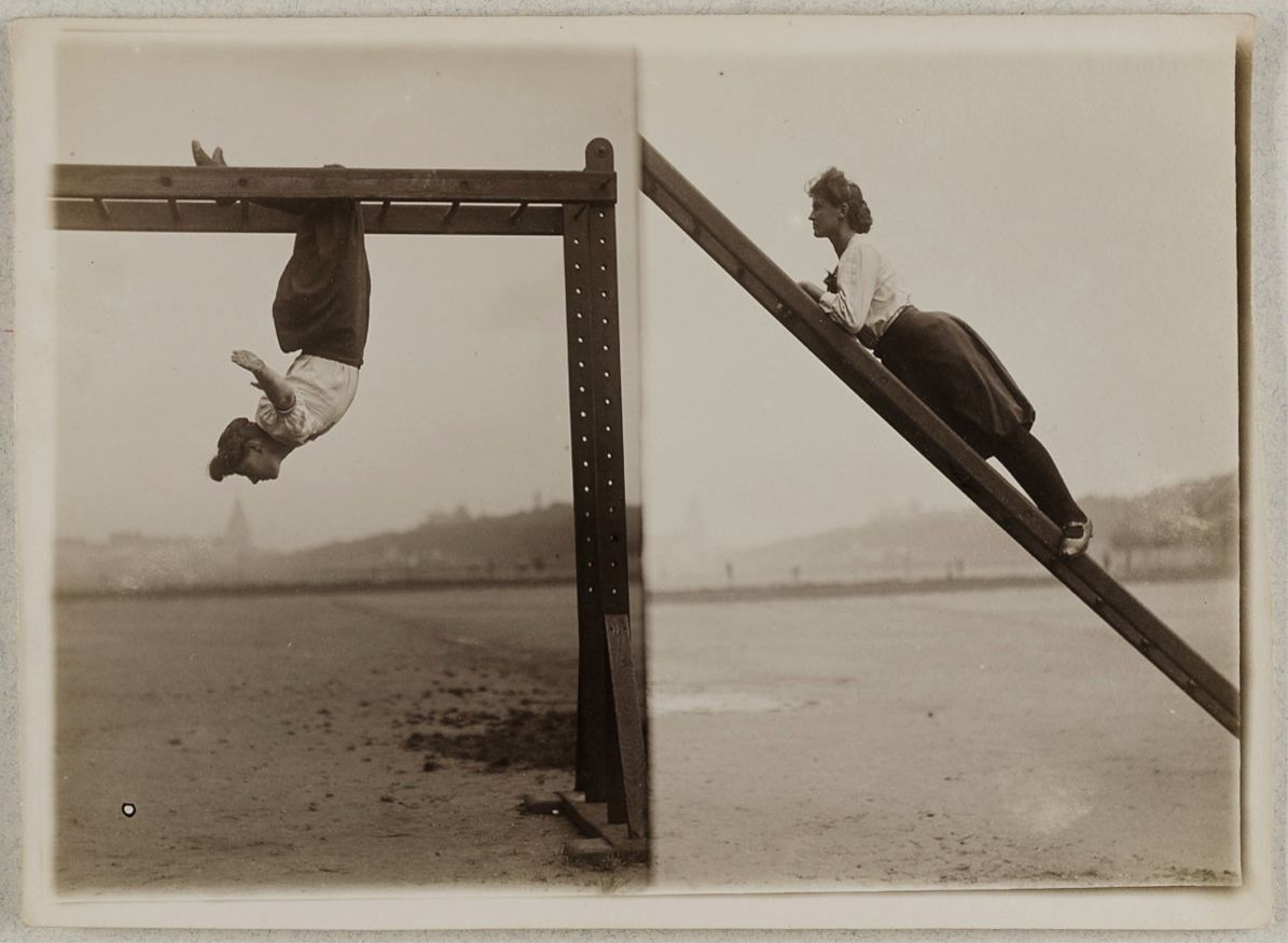Vintage black and white photograph of a person doing gymnastic exercises on wooden apparatus outdoors.