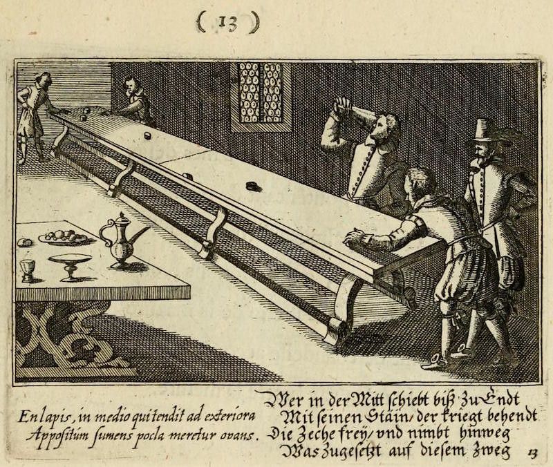 A black and white engraving of a complex mechanical device within a room. Three men are interacting with the device, which appears to be an automated serving system. A table runs through the center of the mechanism, and a goblet and pitcher are placed on one end. The scene is set in a room with a stone floor and a tower in the background.