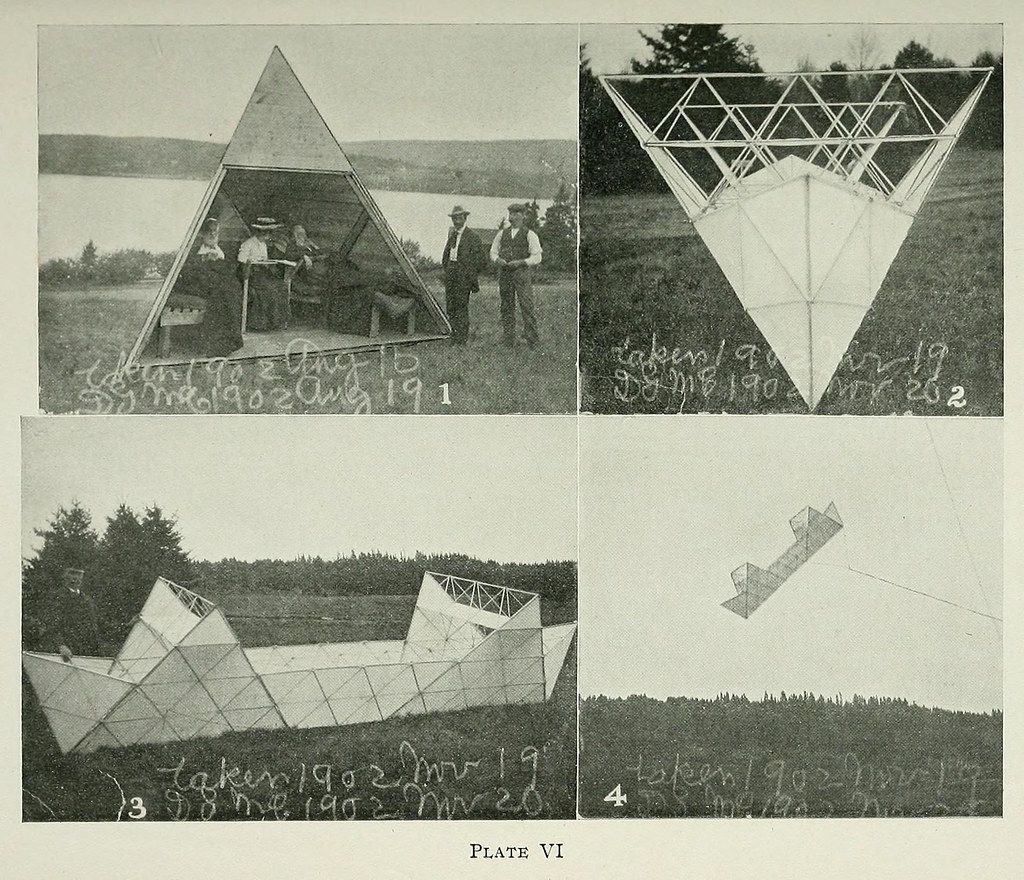 A collage of four black and white photographs depicting a large geometric structure resembling a tetrahedron, constructed from a network of wooden or metal beams. The photographs show the structure from different angles, with men, trees, and an airplane visible in the background.