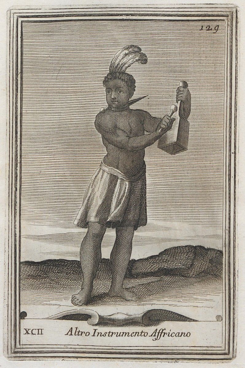 Vintage engraving of an African person playing a long, cylindrical musical instrument, wearing a feathered headgear and a short skirt.