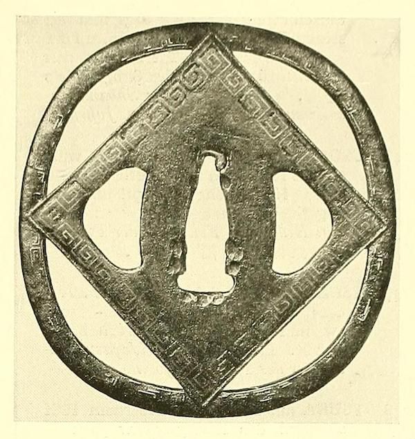 A circular artifact with a diamond-shaped design and a repeating geometric pattern.