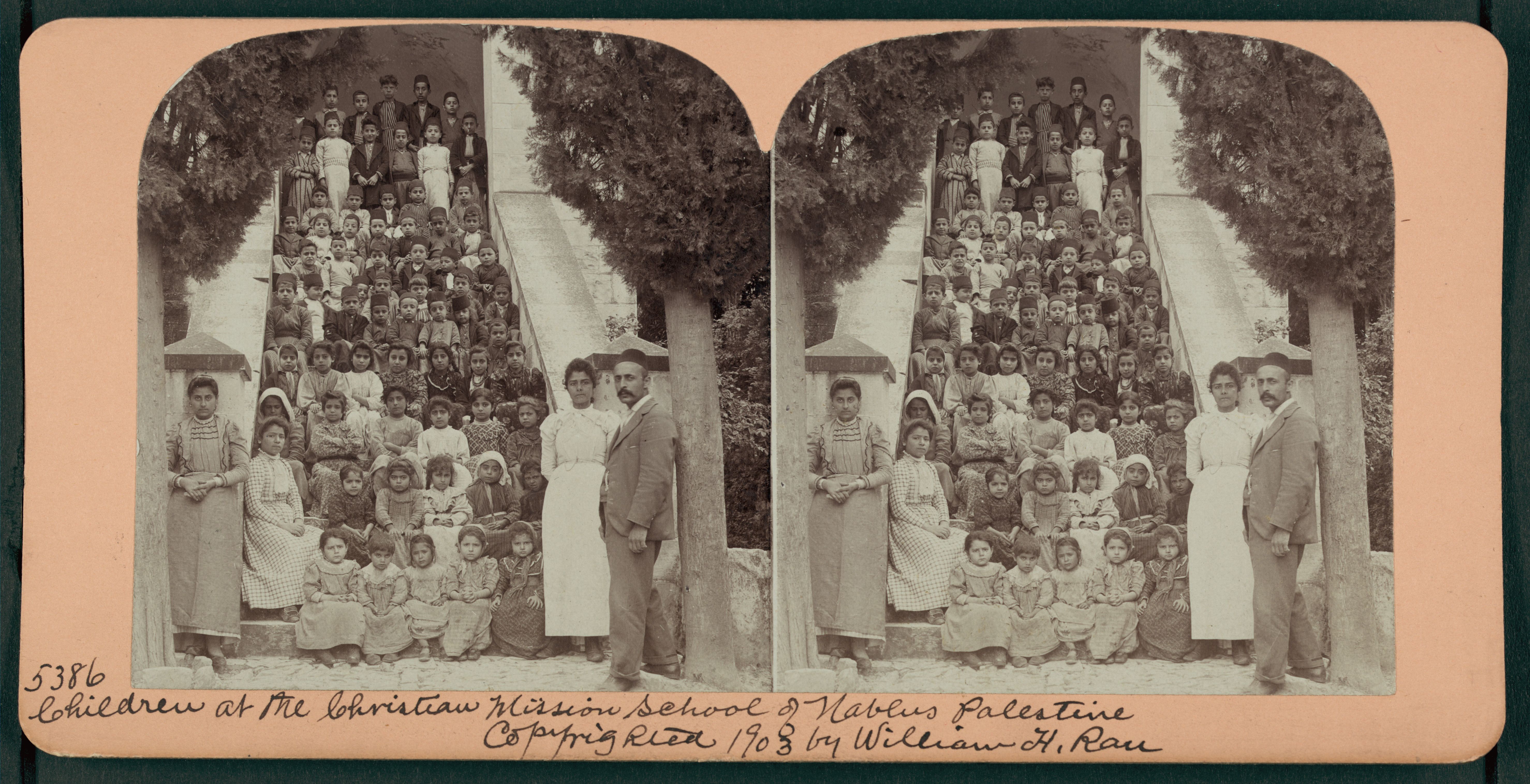 Stereoscope card depicting a large group of children at the Christian Mission School in Nablus, Palestine, circa 1908.