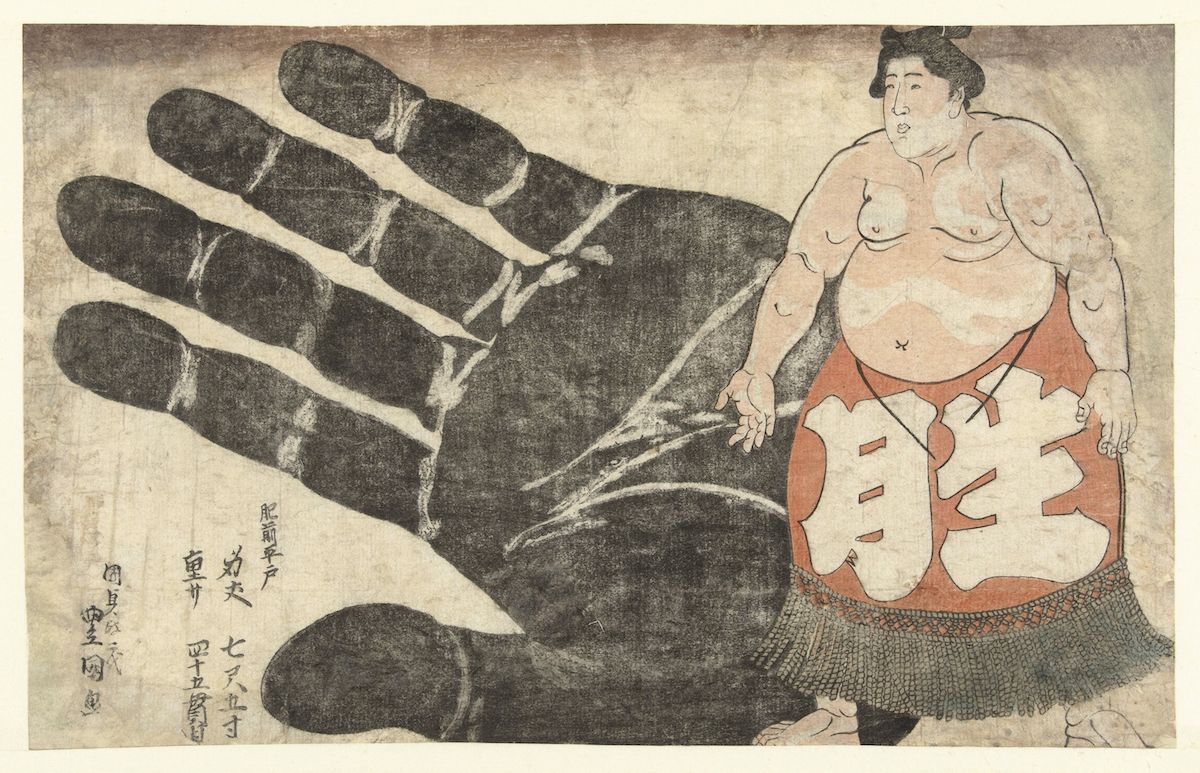 A woodblock print depicting a large hand looming over a sumo wrestler.