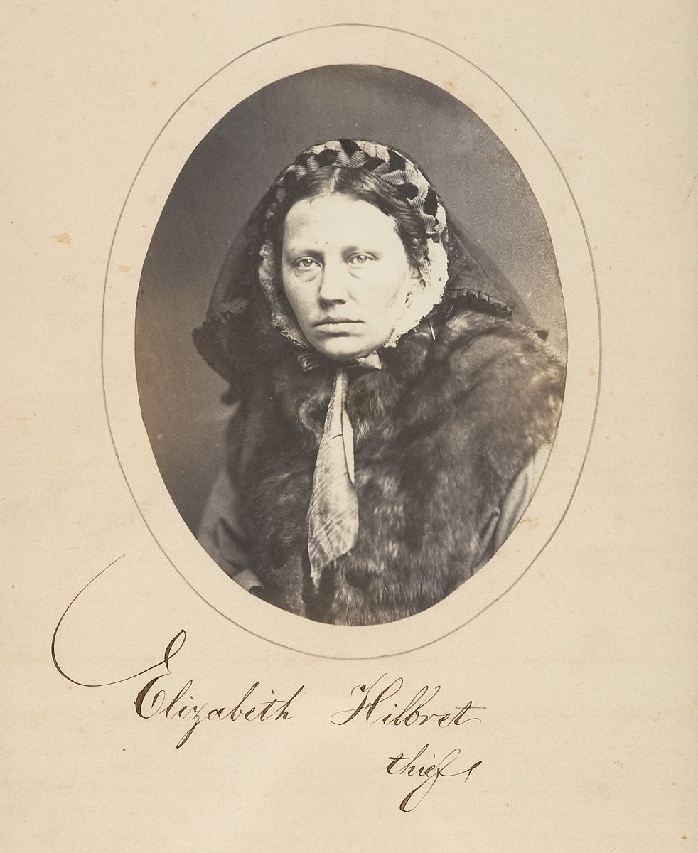 Vintage black and white portrait of Elizabeth Hibbert, identified as a thief, wearing a fur-trimmed coat and decorative headwear.