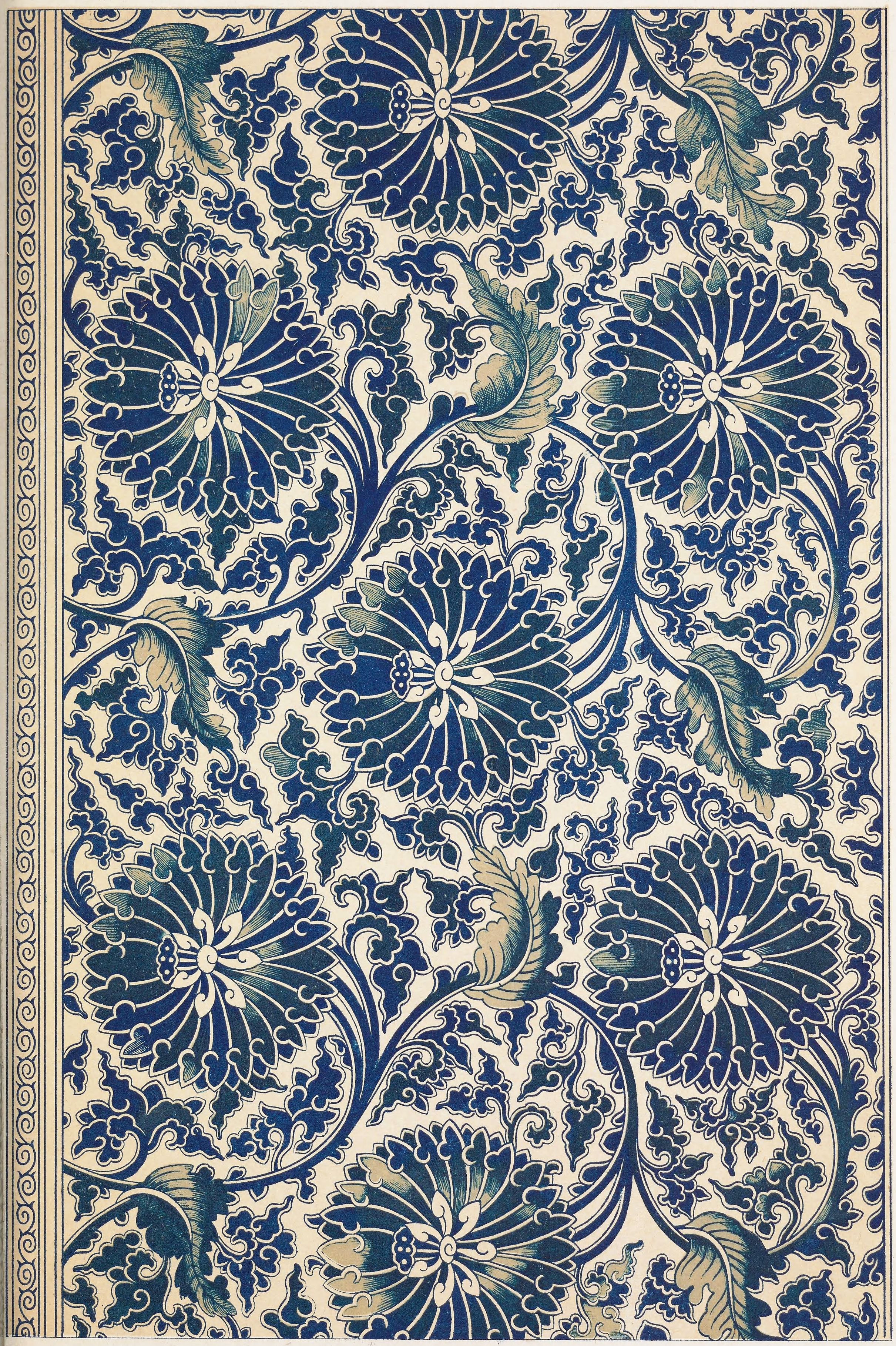 A detailed, ornate pattern featuring navy blue floral motifs on a creamy background, with a narrow geometric border along the edges.