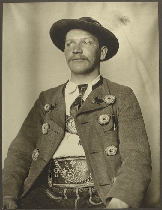 A vintage black and white portrait of a man in traditional attire.