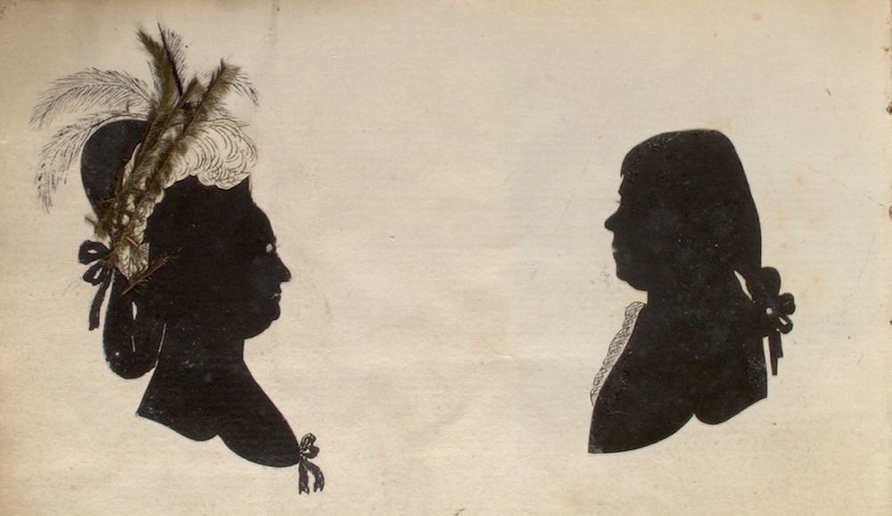 Vintage silhouettes of a woman and a man facing each other.