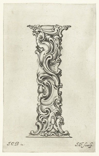 A black and white engraving of a highly ornate capital letter 'I' filled with floral and foliate motifs.