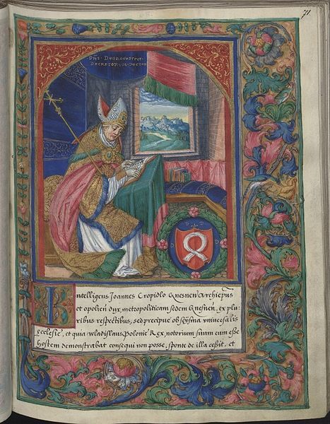 A page from a medieval manuscript with a bishop kneeling in prayer before a framed scene, surrounded by a lush border of floral and foliate designs.