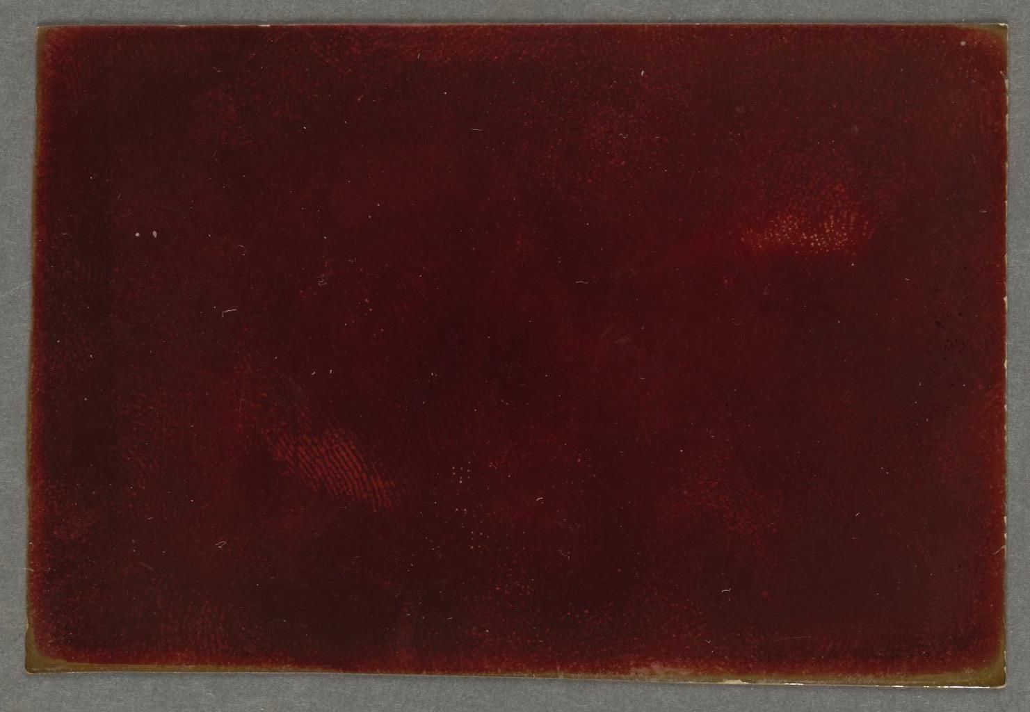 A close-up of a deep burgundy or maroon velvety background with subtle texture and a few faint imperfections.