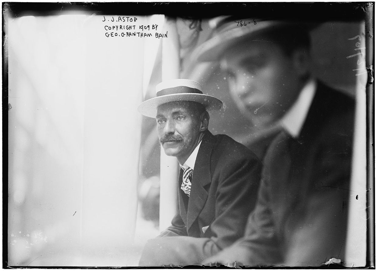 A vintage black and white photograph of a man in a suit and hat.