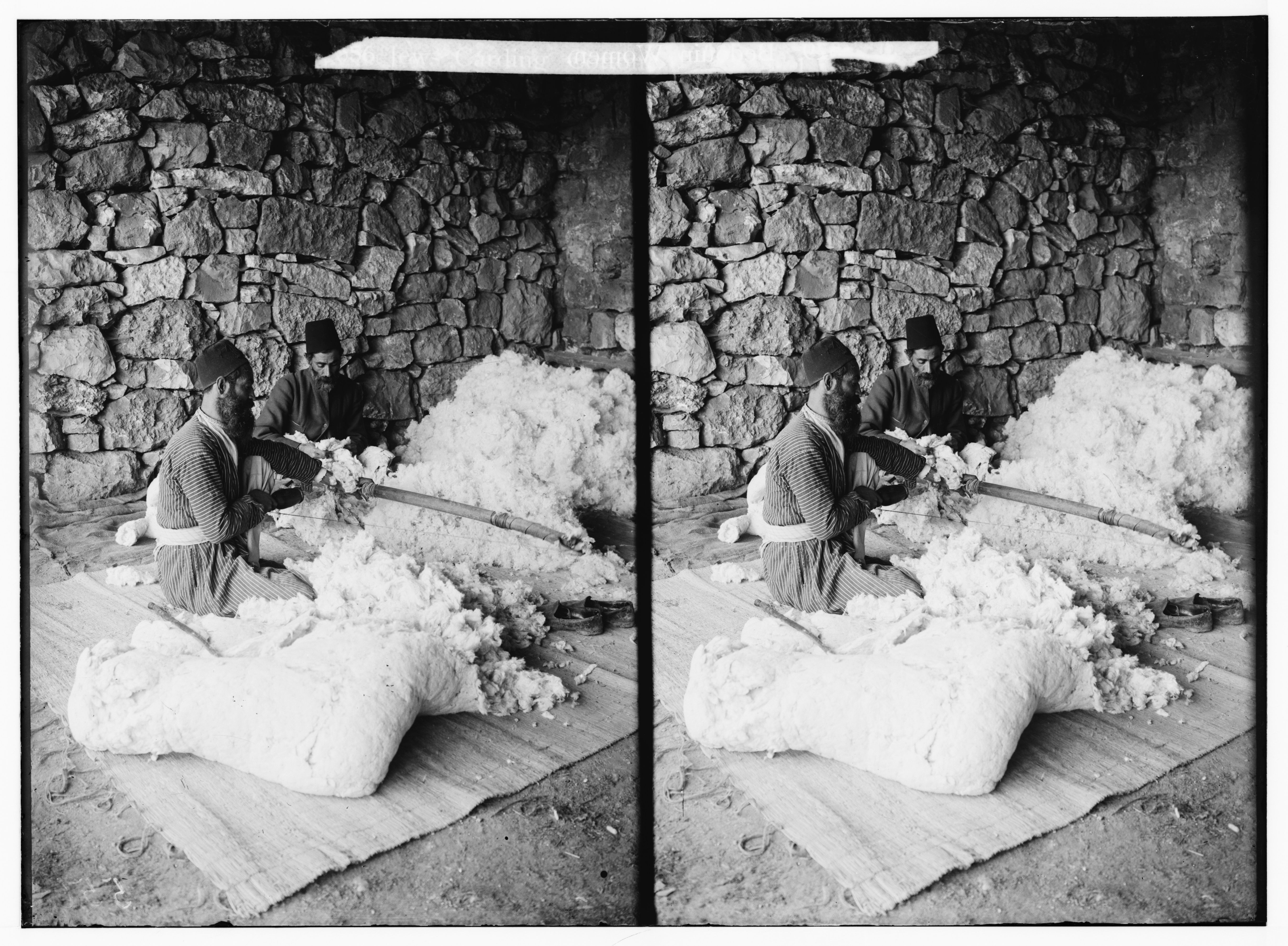 Stereoscopic photograph of a person working with cotton in a workshop.