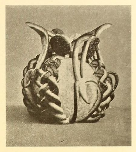 Vintage sepia-toned photograph of an abstract sculpture with a bulbous base and intricate, tentacle-like structures.