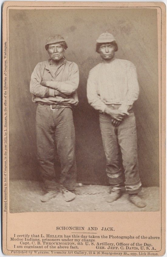 Vintage photograph of two Native American men, Schonchin and Jack, identified as Modoc Indian prisoners, standing side-by-side in a studio setting. The image is accompanied by a certification from Capt. C. B. Throcmorton and Gen. Jeff. C. Davis.