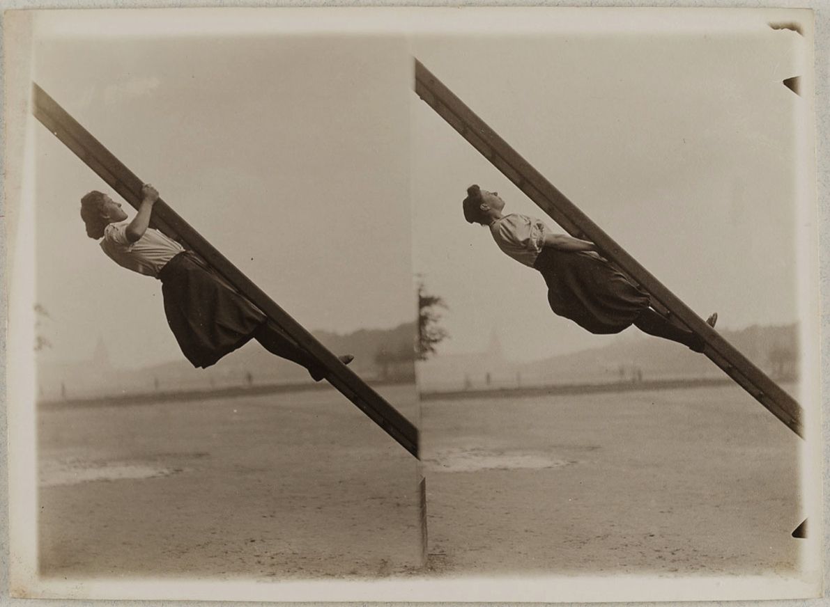 Vintage sepia-toned photograph of a person performing a gymnastic move on a pole, captured in two sequential frames.