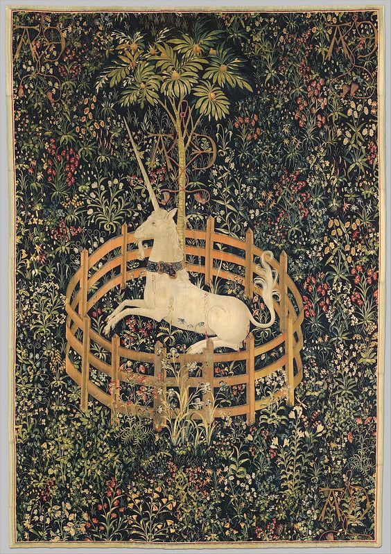 A detailed tapestry depicting a white unicorn enclosed within a circular wooden fence in a dense forest.