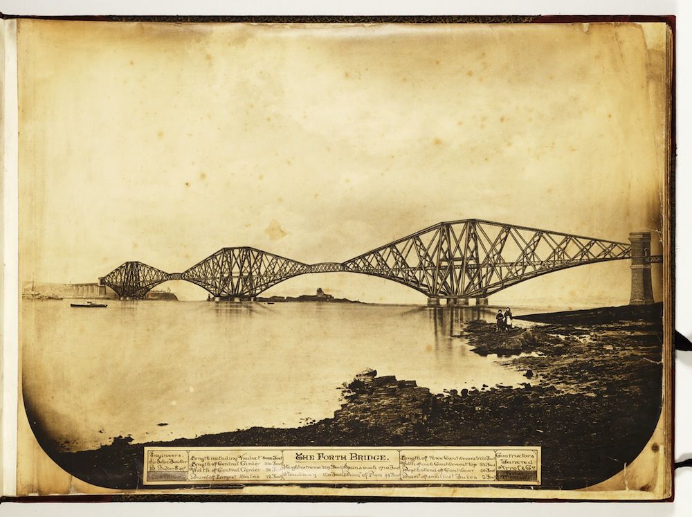 Vintage sepia-toned photograph of the Forth Bridge, a large cantilever railway bridge spanning the Firth of Forth in Scotland.