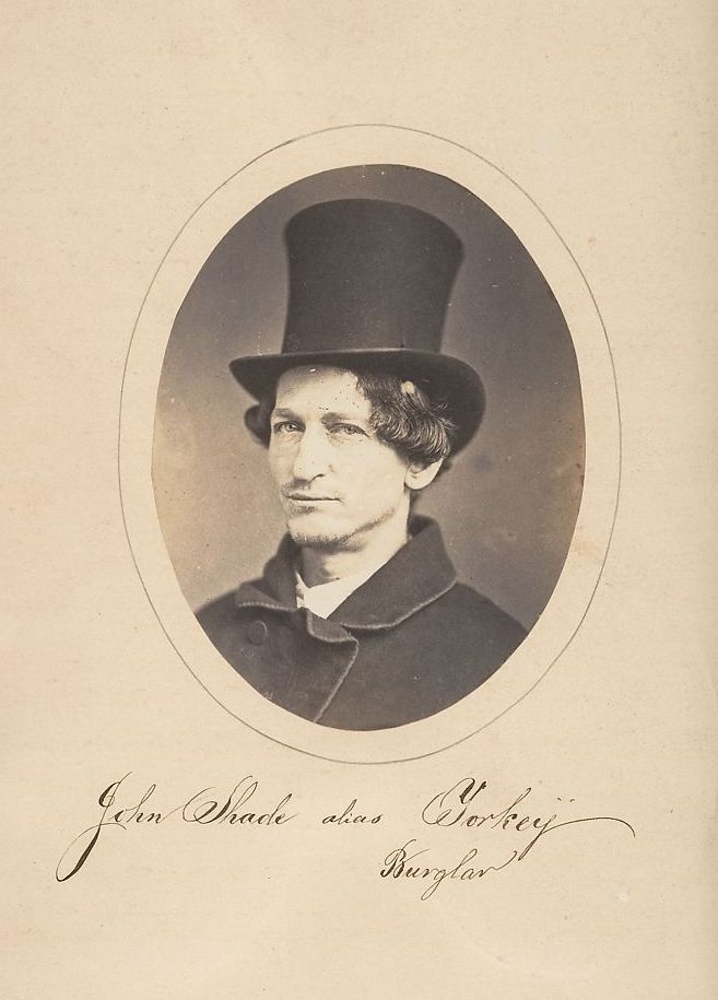 Vintage sepia-toned photograph of John Shackle alias Sorby, identified as a burglar, wearing a top hat and coat.