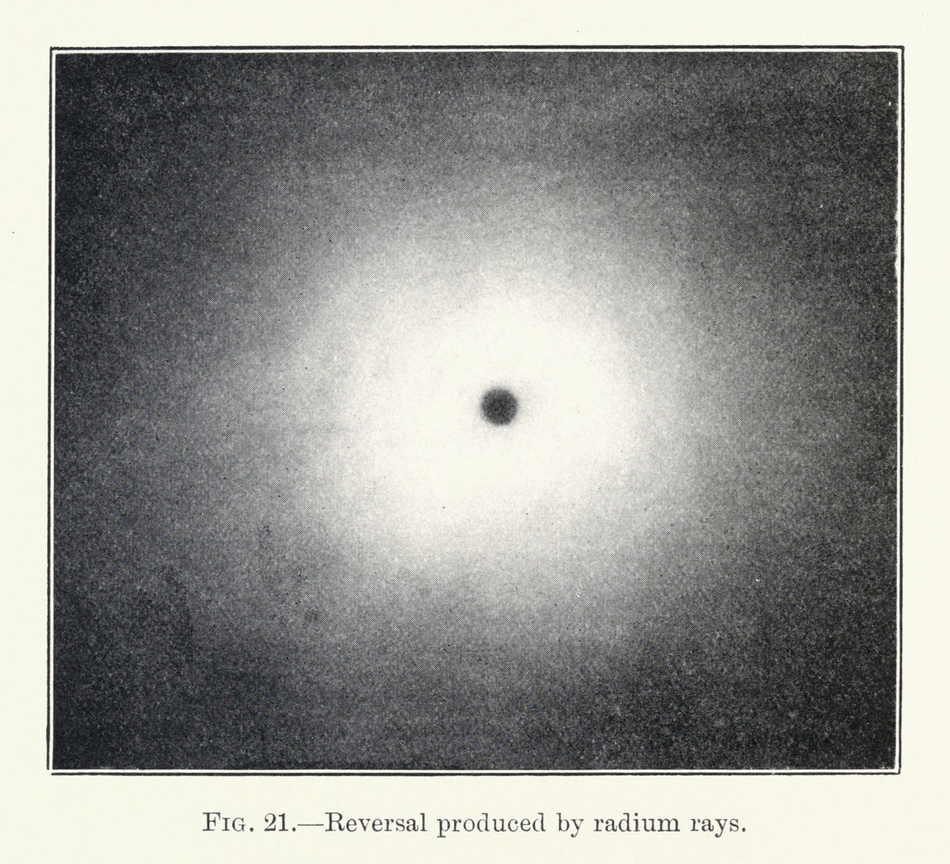 A vintage black and white photograph showing the effect of radium rays, with a dark central spot and radiating rays.