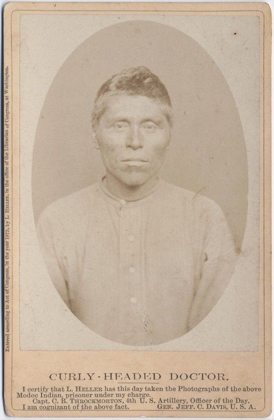 Vintage photograph of a Native American man titled 'Curly-Headed Doctor' with a certification below.