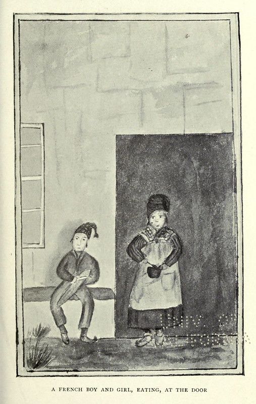 A French boy and girl eating at the door.