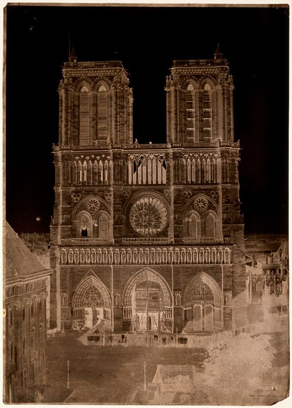 Vintage photograph of Notre Dame Cathedral in Paris, showcasing its western facade, twin towers, rose window, and intricate gothic architecture.