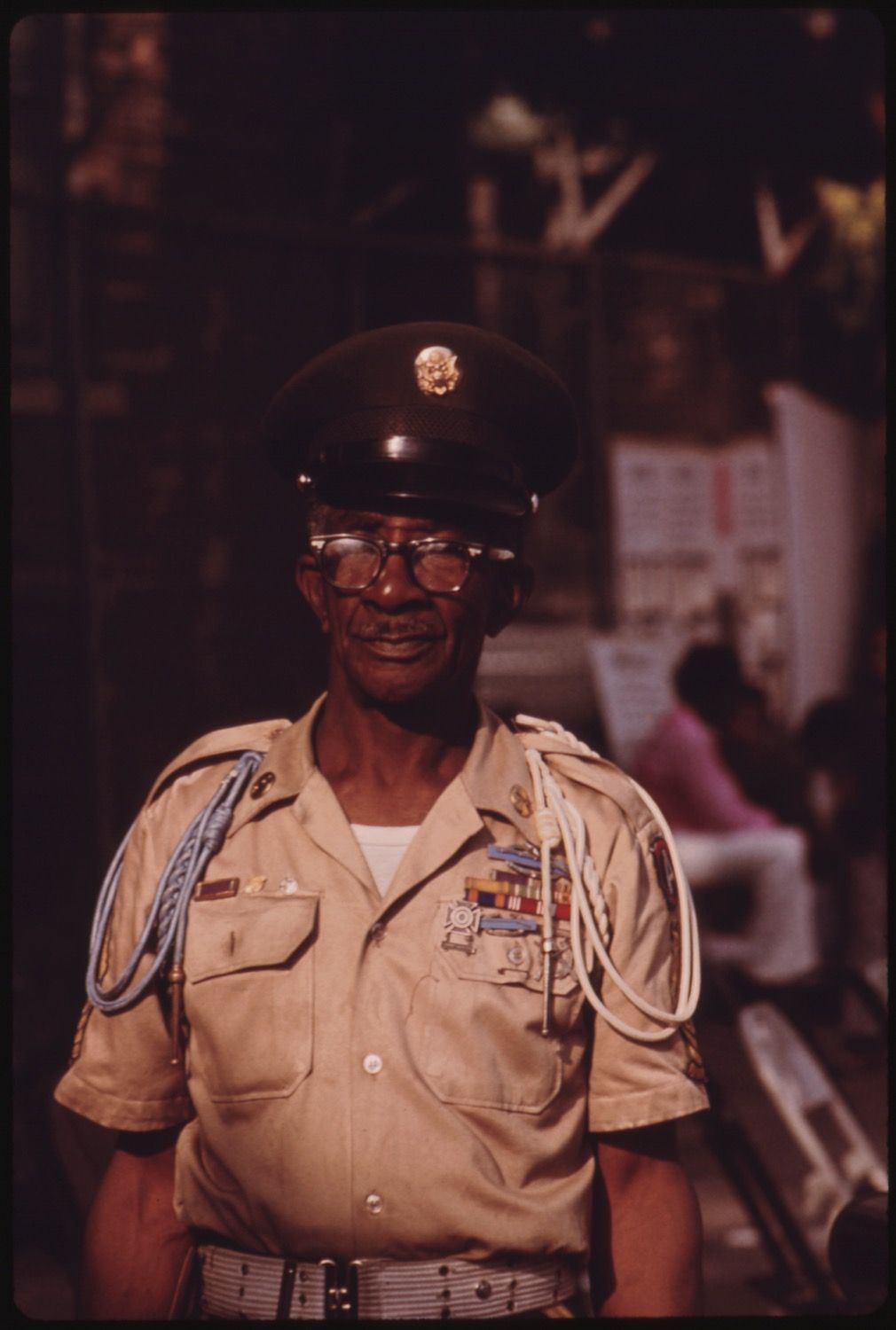 Portrait of an older Black man in a military uniform with medals and a peaked cap.