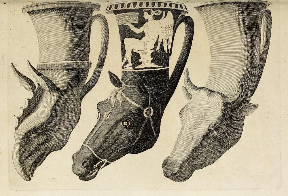 A black and white engraving of three animal heads and a central vessel.