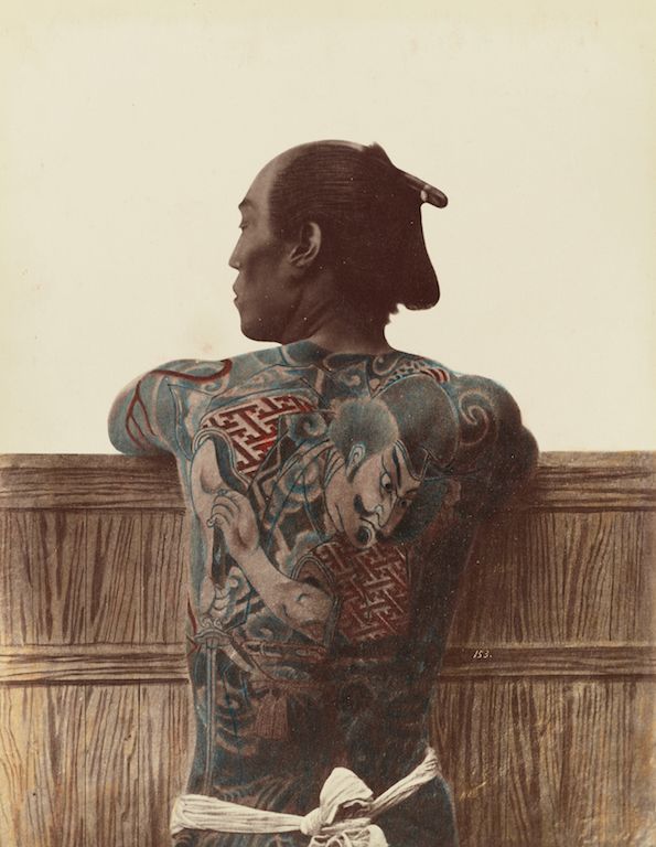 Vintage photograph of a Japanese man with elaborate full-back tattoos.