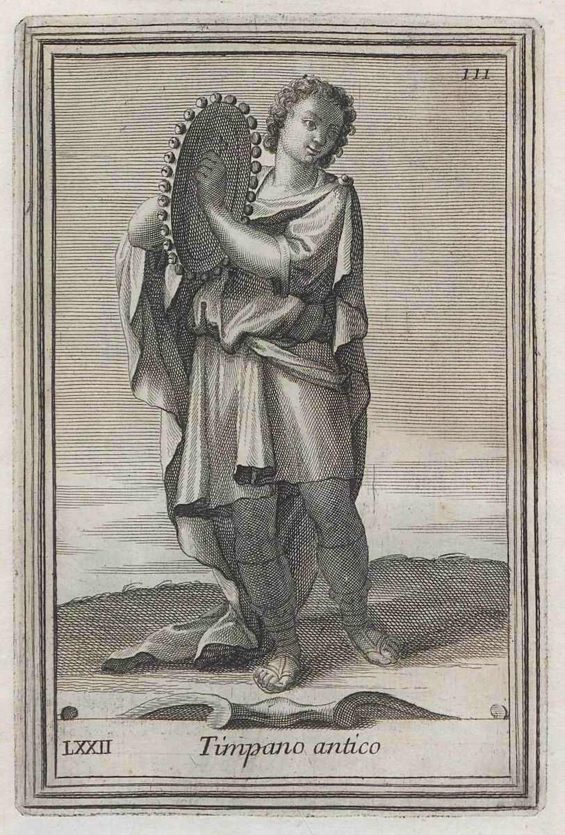 A black and white engraving of a young person holding a large, oval-shaped timpano (a type of drum). The person is standing and facing forward, with a slightly turned head. They are draped in classical-style clothing, consisting of a flowing robe or tunic that reaches their knees. The clothing is detailed with folds and drapery, suggesting a sense of movement and texture. The person's legs are partially covered by what appears to be leggings or stockings. The timpano is held in front of the person, with one hand resting on its surface. The drum itself is intricately detailed, with a textured surface and a decorative rim. The person's expression is neutral, and their gaze is directed towards the viewer. At the bottom of the image, there is a rectangular banner with the text 'Timpano antico' written in elegant script. To the left of the banner is the Roman numeral 'LXXII'. In the upper right corner, the number '111' is visible.