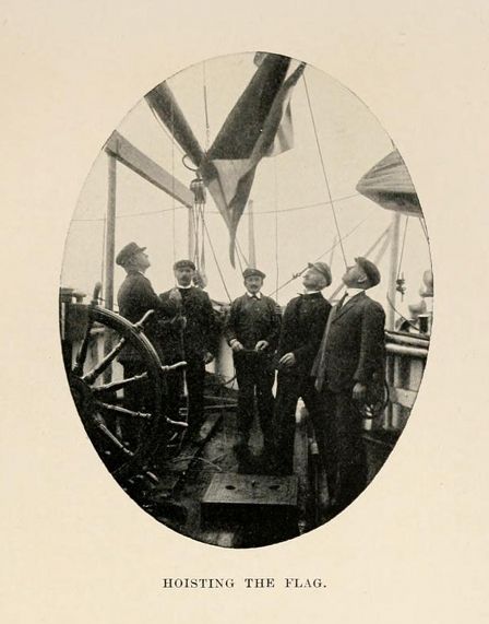 A vintage photograph of five men on the deck of a ship hoisting a flag.