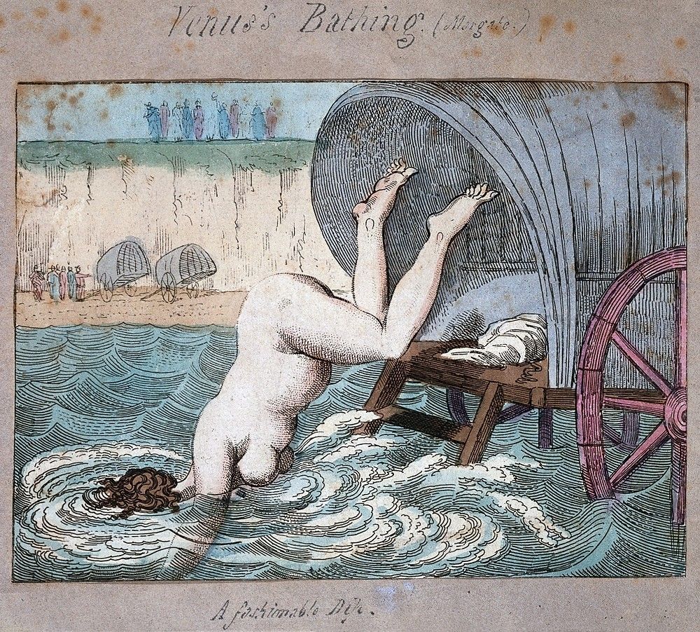 A vintage cartoon titled 'Vinus's Bathing Machine' depicts a person falling headfirst into the sea, with a bathing machine and people on the beach in the background.