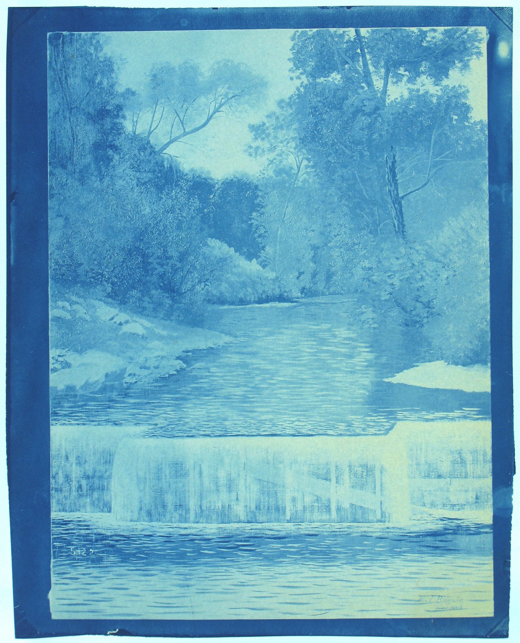 Cyanotype photograph of a river landscape with trees and rocks.