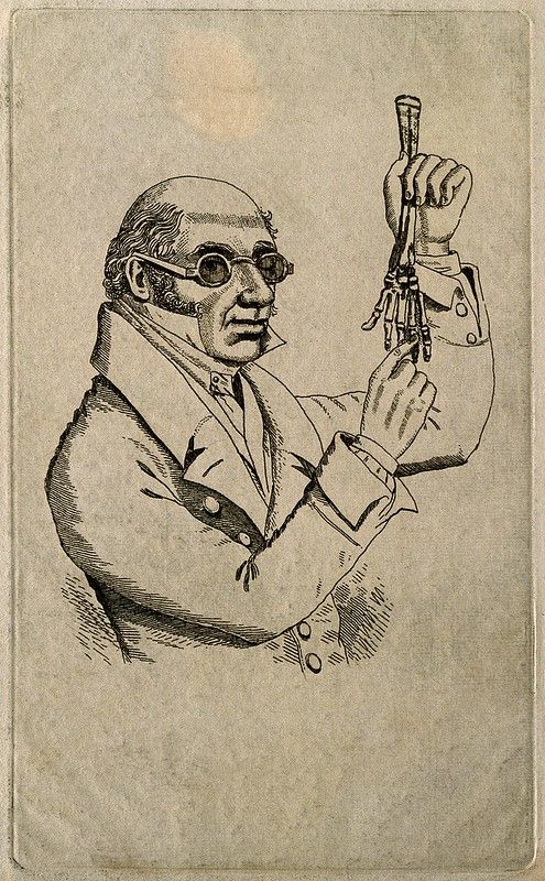 Vintage illustration of a man holding a mechanical hand.
