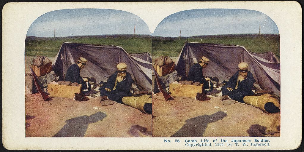 Stereoscopic photograph of a Japanese soldier in a camp setting, dated 1905.