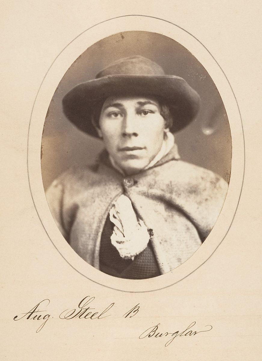 Sepia-toned portrait of Aug. Steel, identified as a burglar, wearing a hat and textured coat.
