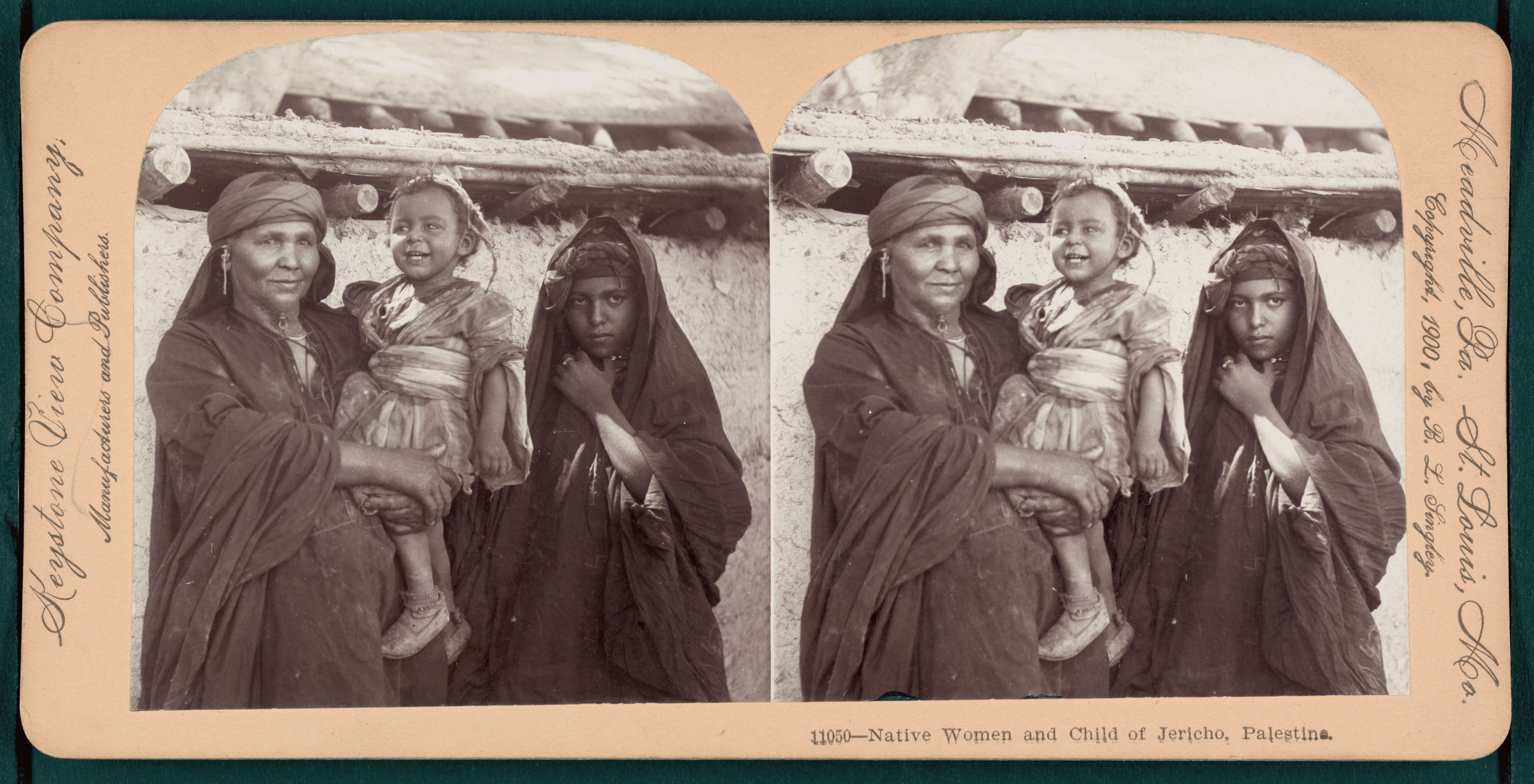 Stereoscopic photograph of two women and a child in Jericho, Palestine, wearing traditional clothing and head coverings.