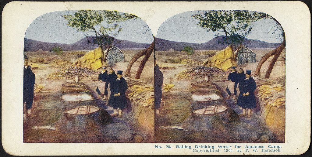Stereoscopic photograph from 1905 showing Japanese soldiers boiling water for drinking in a camp setting.