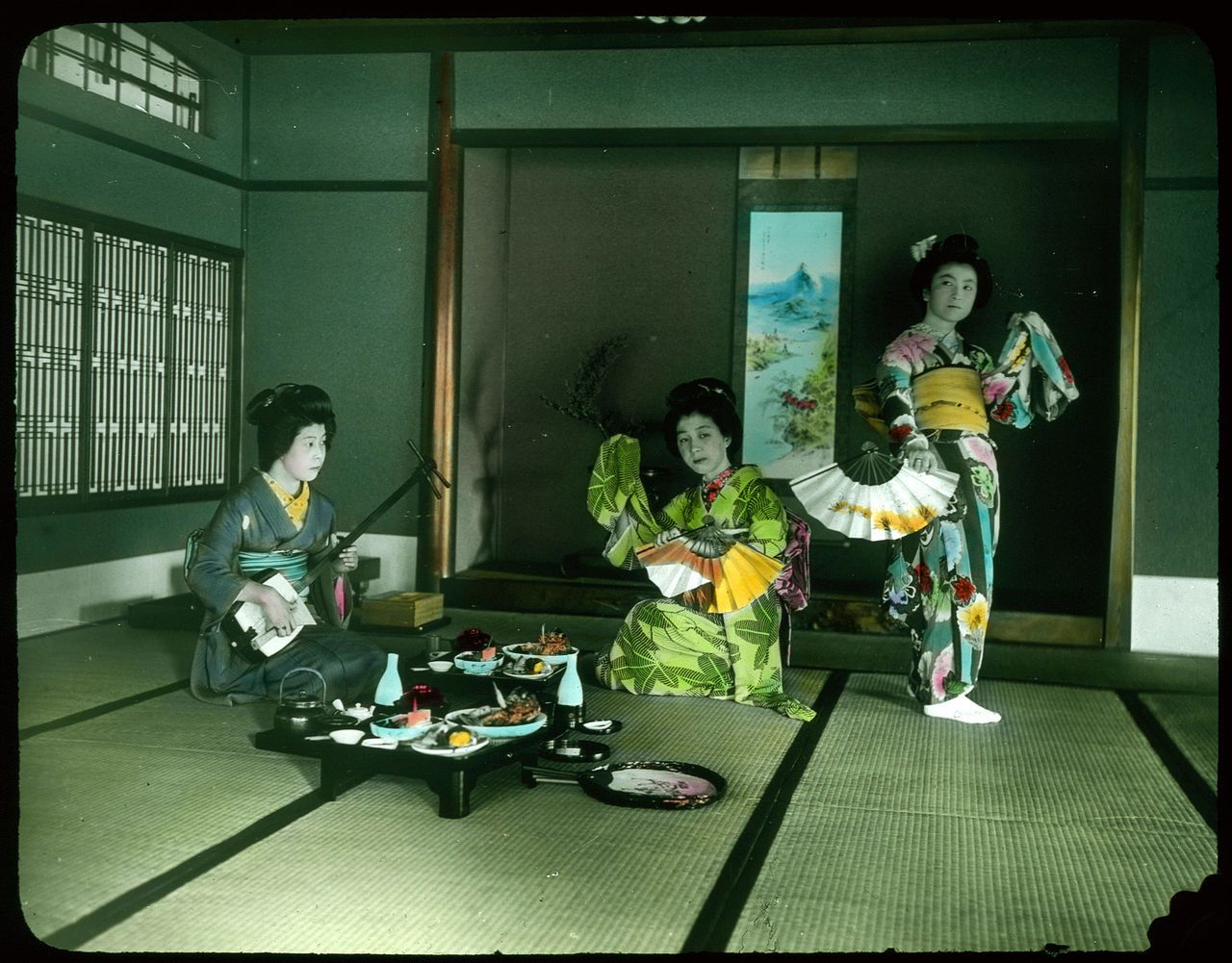 Three women in kimonos in a traditional Japanese room.